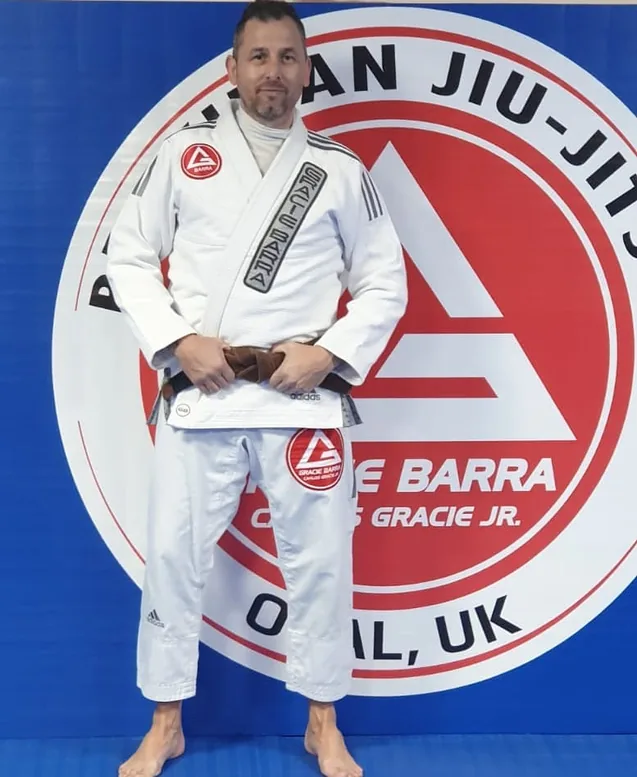 Neil in a white BJJ gi at Gracie Barra