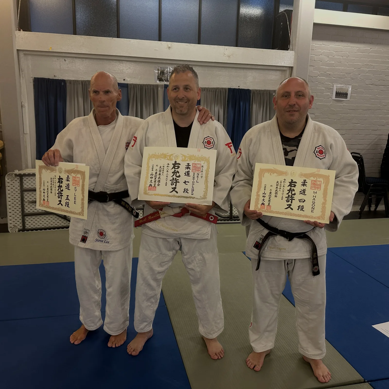 7th Dan presentation, Mid Sussex Martial Arts, June 2026: Neil (centre) with Steve Lee (5th Dan) and Marc Hagone (4th Dan)